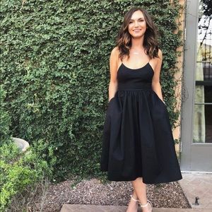 Showpo tea length black dress with pockets!